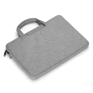 Detail of grey waterproof laptop bag showing reinforced handles and dual metal zippers