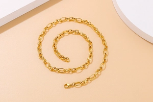 Detailed shot of golden stainless steel link necklace with alternating smooth and textured loops