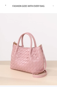 Detailed view of pink hand-woven mini bucket bag featuring leather texture and crossbody strap