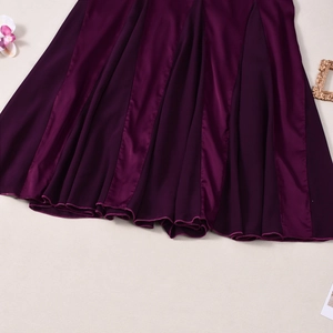 Detail of elegant dark purple satin dress hem with silk texture and smooth glossy finish