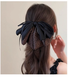 Detailed back view of double-layered leopard print and black satin bow hair claw clip