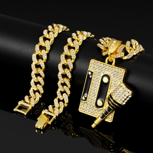 Macro shot of gold Cuban chain necklace with iced out cassette and microphone pendant