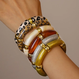 Close-up of acrylic bamboo-style bangle bracelets with leopard print and amber resin