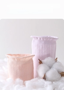 Close-up of ribbed cuffs on silk mesh socks in soft pink and purple knit texture