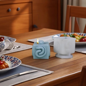 Square silicone mold for DIY candles featuring a detailed 3D snake relief and blue wax finish
