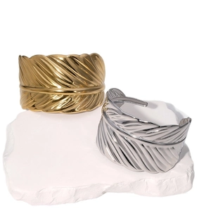 Gold and silver stainless steel leaf open bracelets with fine feather texture on stone