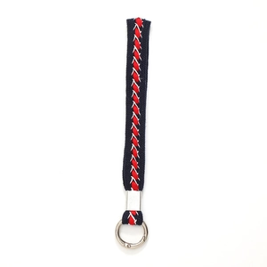 Blue, red, and white woven wrist strap keychain with silver metal clip on white background