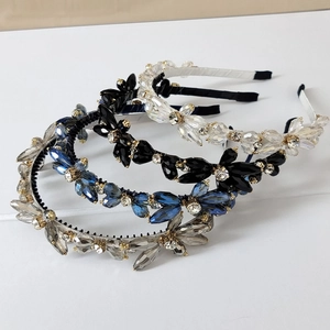 Detail of handcrafted crystal beaded headbands with floral cut stones and gold accents