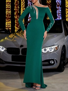Elegant dark green long-sleeve evening gown with silver sequins and mesh shoulder detail