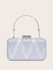 Close-up of sparkling silver rhinestone evening bag with round metal handle and square clasp