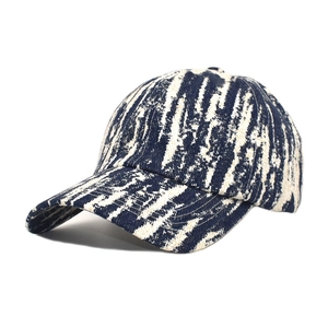 Close-up detail of navy and beige jacquard textured tie-dye baseball cap fabric