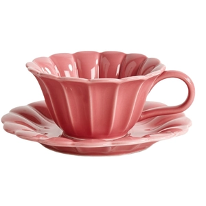 Pink petal-shaped ceramic coffee cup and saucer set with a glossy glaze on white background
