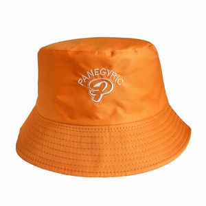 Close-up of orange reversible bucket hat with white PANEGYRIC embroidery and logo