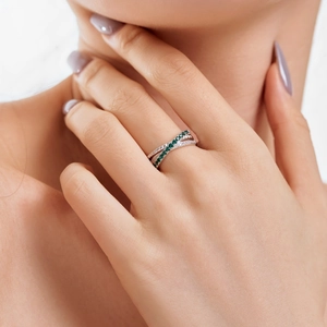 Detail of s925 silver ring featuring layered green and white zircon pavé setting