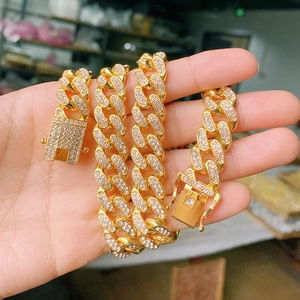 Close-up of golden Cuban link chain with detailed iced out rhinestones and secure clasp