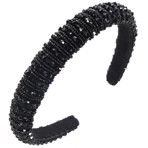 Macro shot of handcrafted black faceted crystal beads on a padded baroque headband