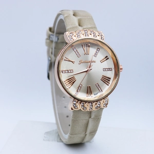 Macro side view of luxury women's crown watch with rhinestone bezel and leather strap
