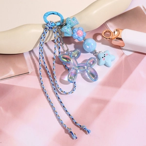 Détail d'un pendentif chien ballon irisé bleu avec cordon tressé et perles