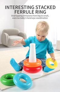 Baby playing with colorful rainbow stacking rings toy to improve hand-eye coordination