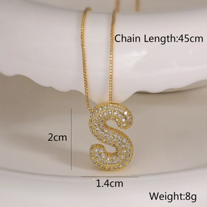Detailed view of gold necklace with S-shaped pendant and cubic zirconia dimensions