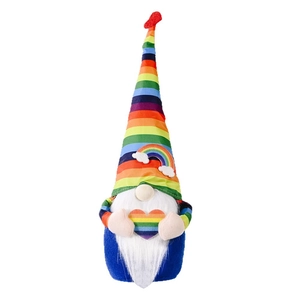 Rainbow stripe gnome doll with white beard holding a heart on a white background