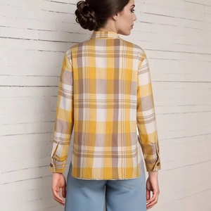 Rear view of long sleeve plaid shirt in yellow and blue colors on a white brick background