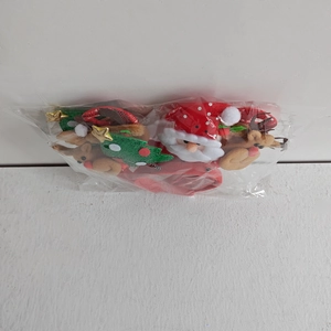Detail of 4pcs Christmas headband set with Santa and reindeer motifs in clear polybag