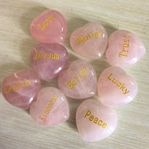 Nine heart-shaped natural rose quartz stones with gold engraved inspirational words