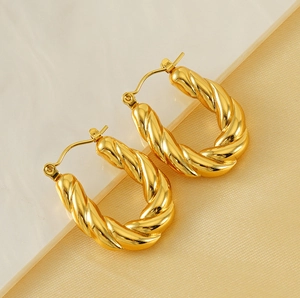 Detailed view of gold-plated twisted U-shape hoop earrings with spiral texture detail
