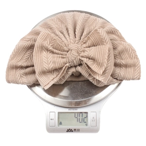 Detail shot of lightweight infant turban hat weighing 40.2g with soft bow and knit pattern