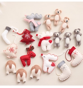 Flat lay of handmade wool felt Christmas ornaments featuring reindeer, trees and bear shapes