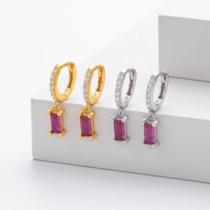 Detail view of 925 silver hoop earrings with rectangular red ruby pendants on white stand