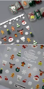 Macro detail of 5D embossed Christmas nail stickers with Santa Claus and reindeer designs