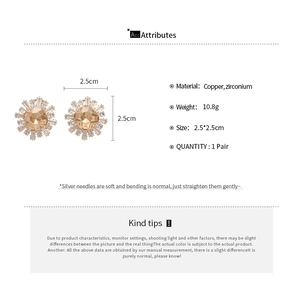 Macro shot of sun-shaped zircon earrings in champagne gold finish with precise measurements