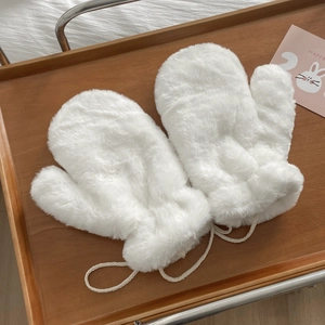 Close-up of white plush faux fur mittens with a lanyard, laid on a rustic wooden tray