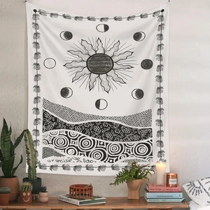 Bohemian tapestry with sun moon and mountain patterns in a cozy home decor setting
