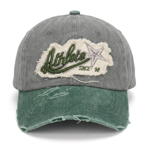 Detail of distressed brim and Athlete embroidery on vintage washed cotton baseball cap