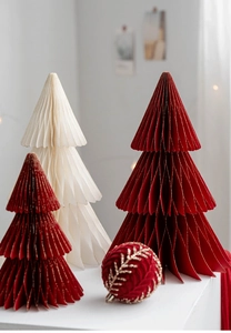 Macro detail of paper honeycomb Christmas trees and velvet embroidered ornament
