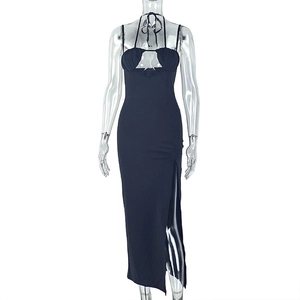Detail of black halter neck dress with front cutout and high side slit design
