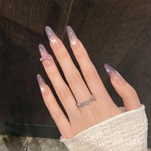 Silver wave ring with pavé crystals shown with purple gradient long press-on nails