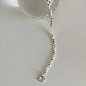 Macro shot of minimalist S925 sterling silver beaded bracelet with spring clasp closure