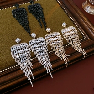 Detailed view of luxury long tassel earrings with sparkling rhinestones in three colors