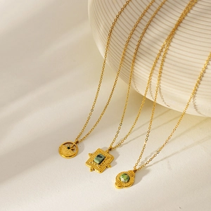 Detail of vintage gold-plated necklaces with green turquoise stones and French baroque pendants