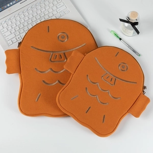 Detail of cute fish-shaped plush laptop sleeve in orange velvet with embroidery