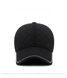 Front view of black quilted baseball cap featuring diamond stitching and metal logo