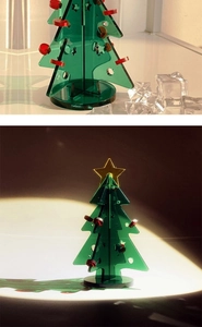 Macro view of mini green acrylic Christmas tree desktop decoration with red dots