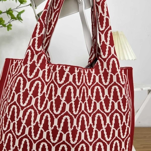 Close-up of red and white wave pattern knitting texture on spacious tote bag