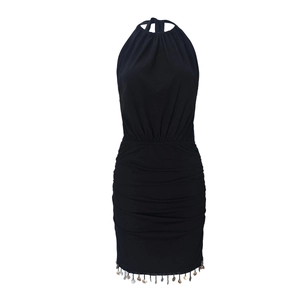 Detail view of backless halter dress featuring pleated texture and fringe hem