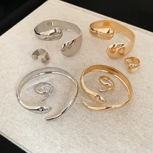 Minimalist gold and silver teardrop jewelry set with polished open bracelet and ring