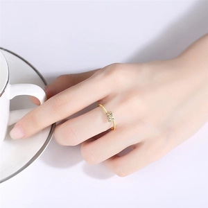 Close-up of S925 sterling silver gold ring with cubic zirconia cluster on a hand